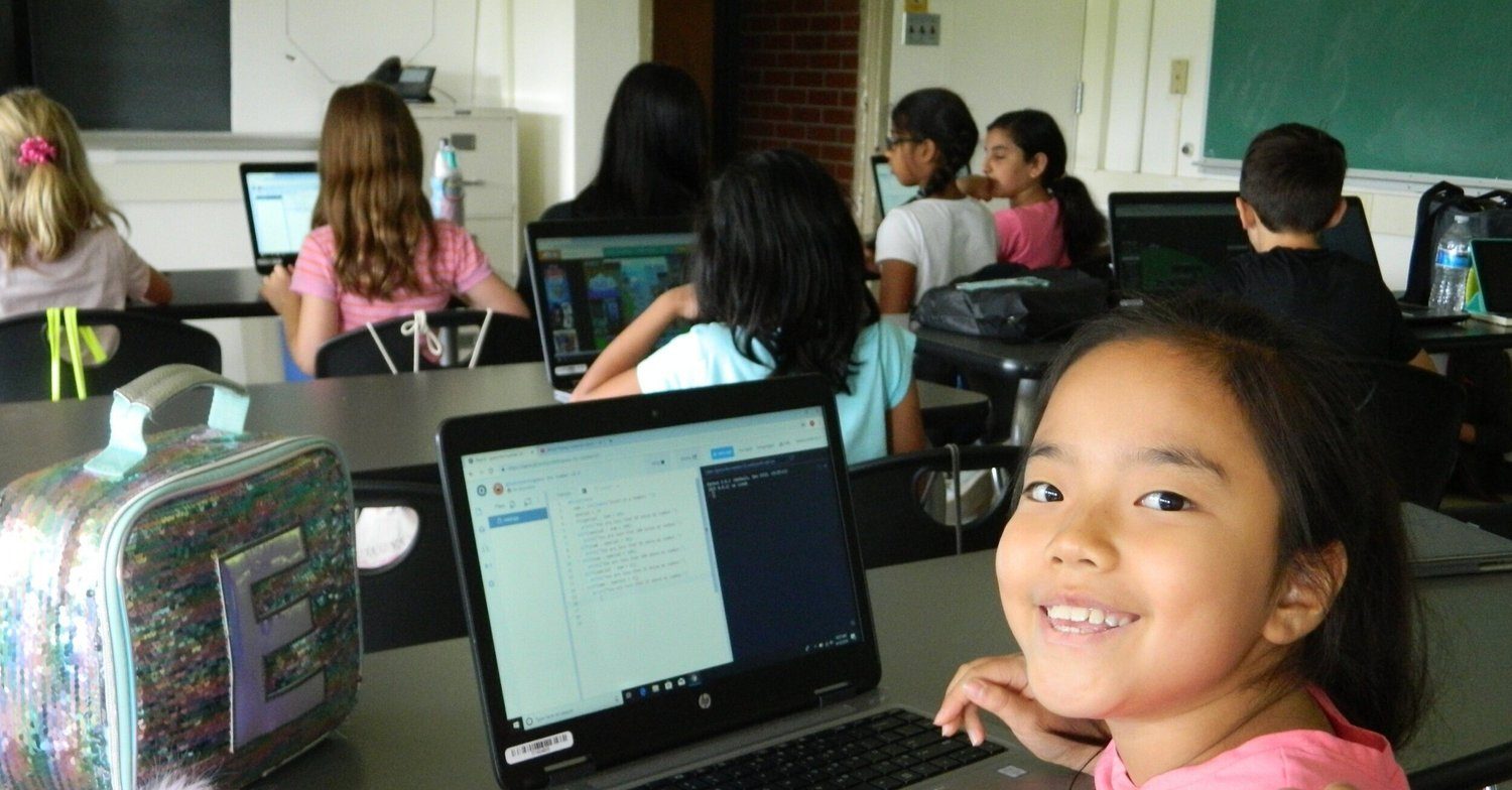 A high-school mentor helping a younger student.
