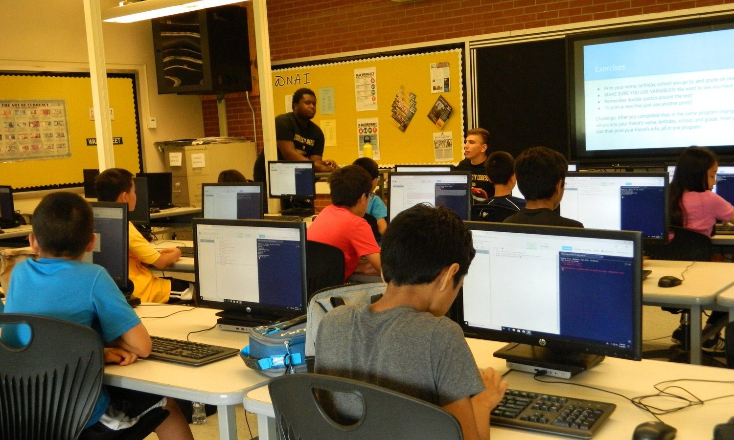Students coding at laptops during a Steel City Codes chapter.
